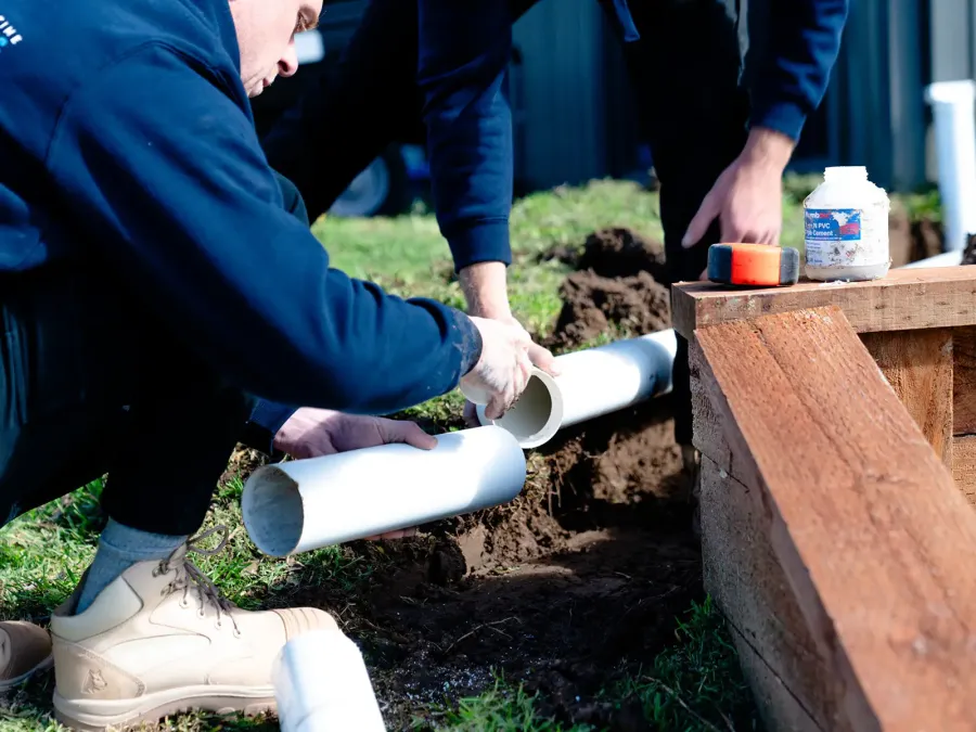 Plumber repairing a burst pipe