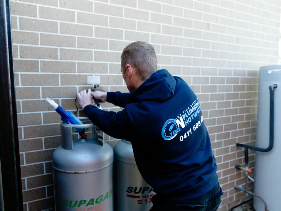 Licensed gas fitter installing a gas appliance
