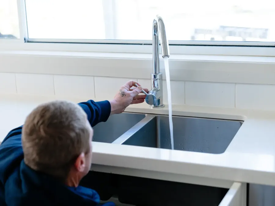 Plumber repairing a leaking tap