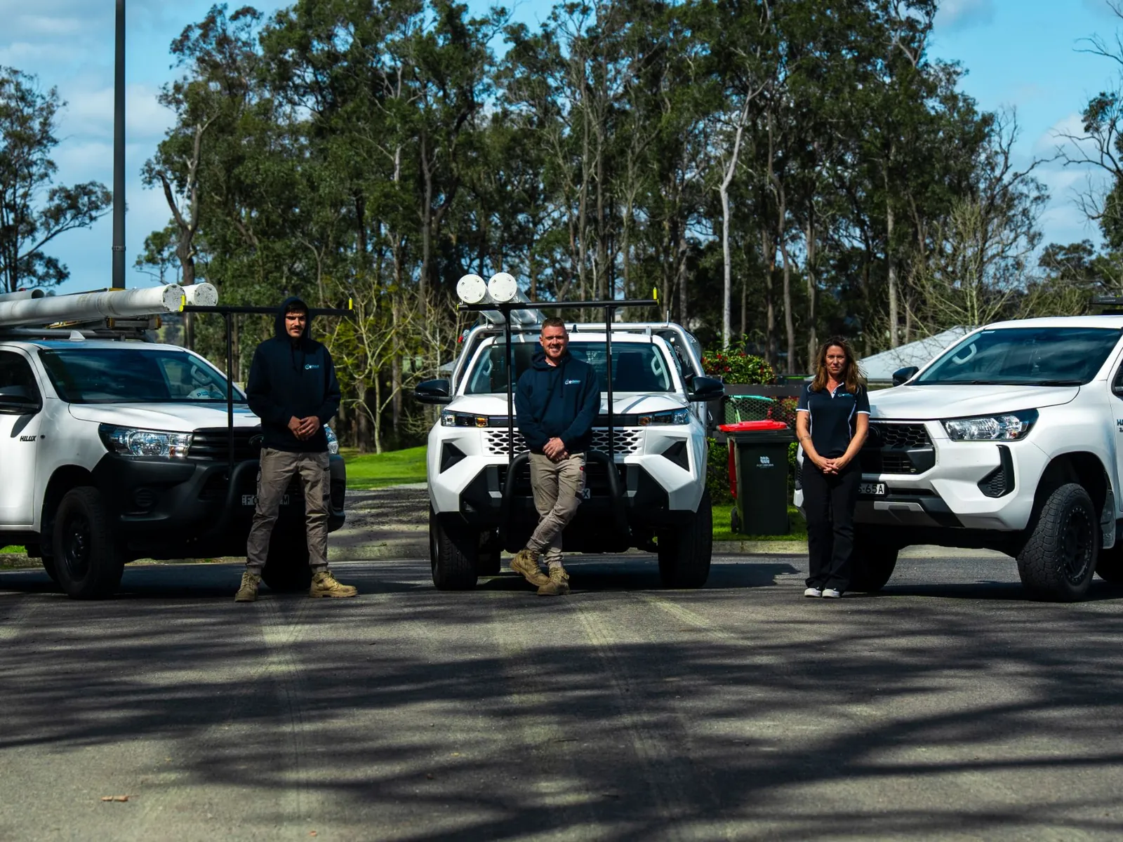 The On Time Plumbing & Hot Water team with their service vehicles