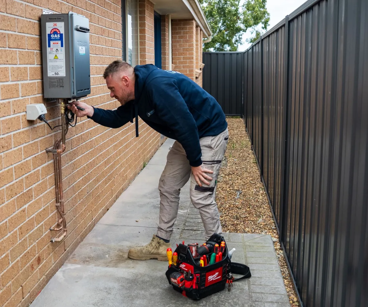 Licensed gas fitter installing a gas appliance