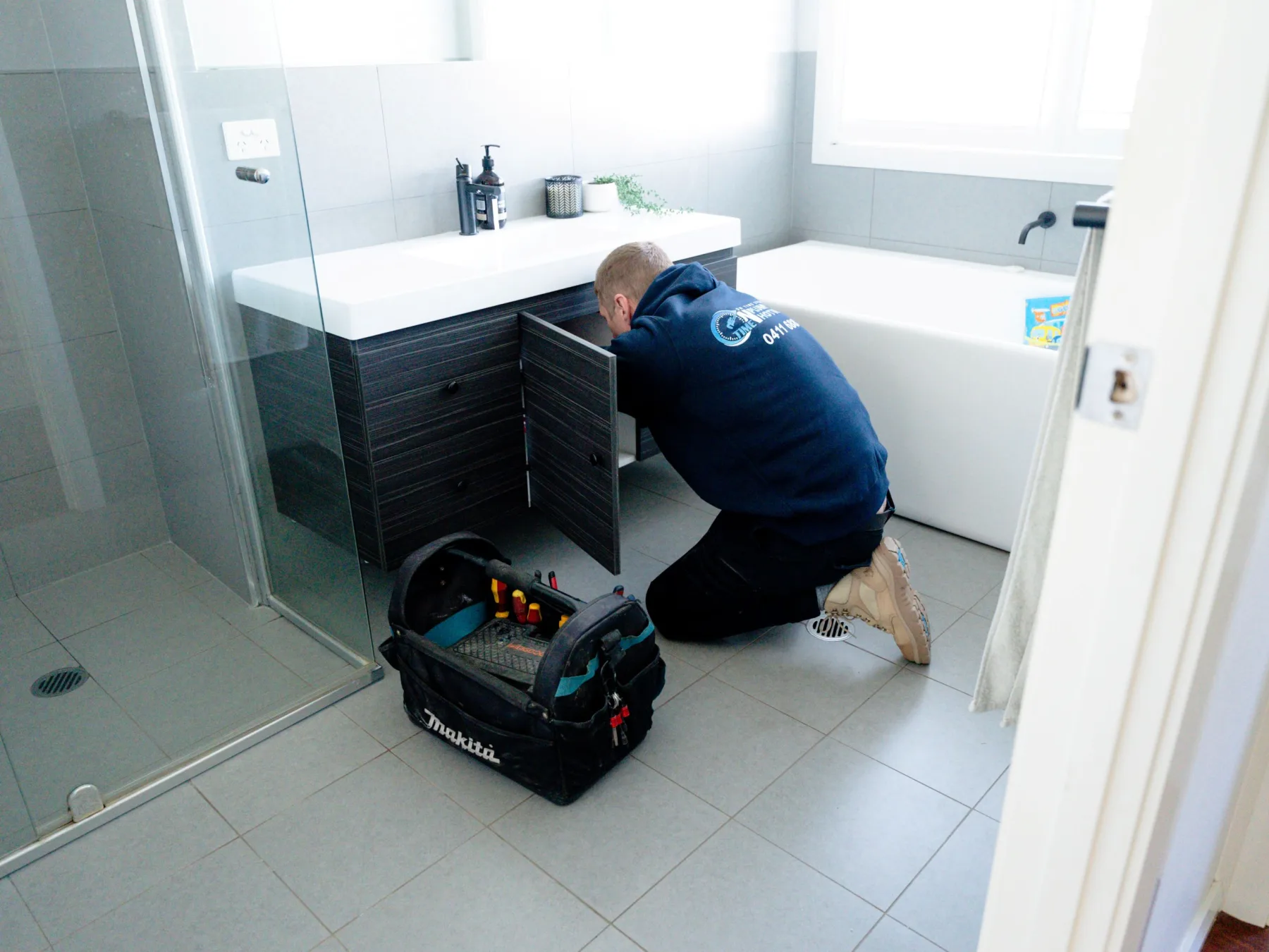 Plumber repairing a blocked toilet