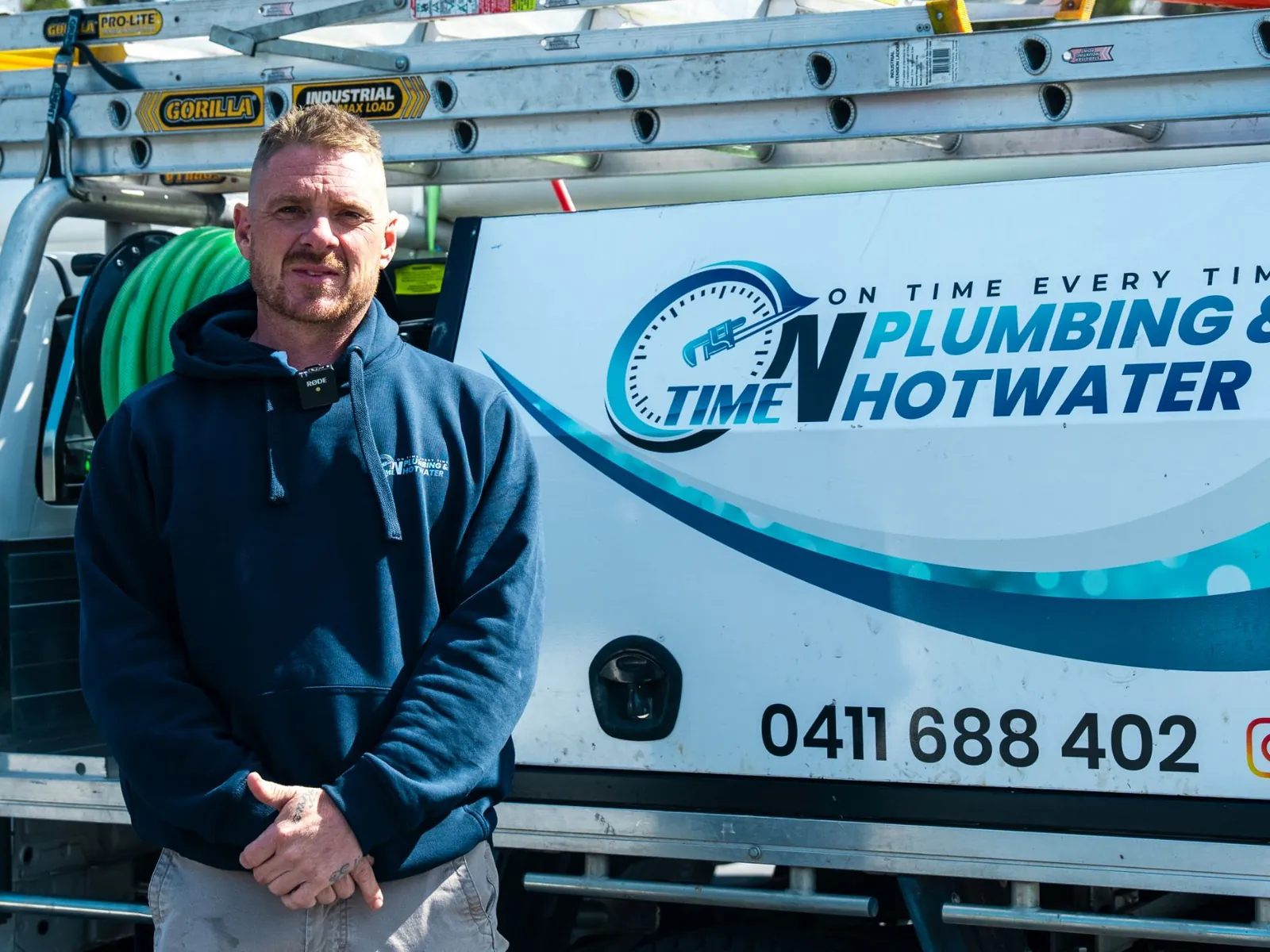 Jared from On Time Plumbing & Hot Water in front of a branded service ute