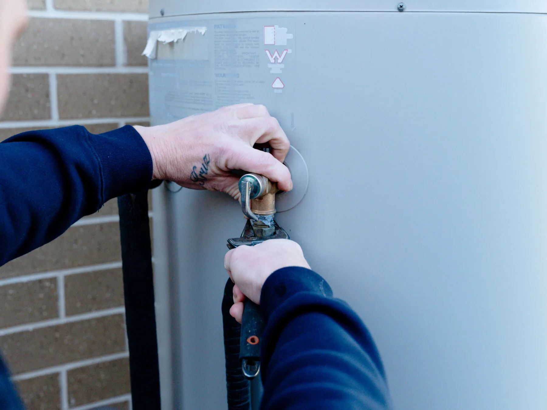 Plumber repairing a hot water system